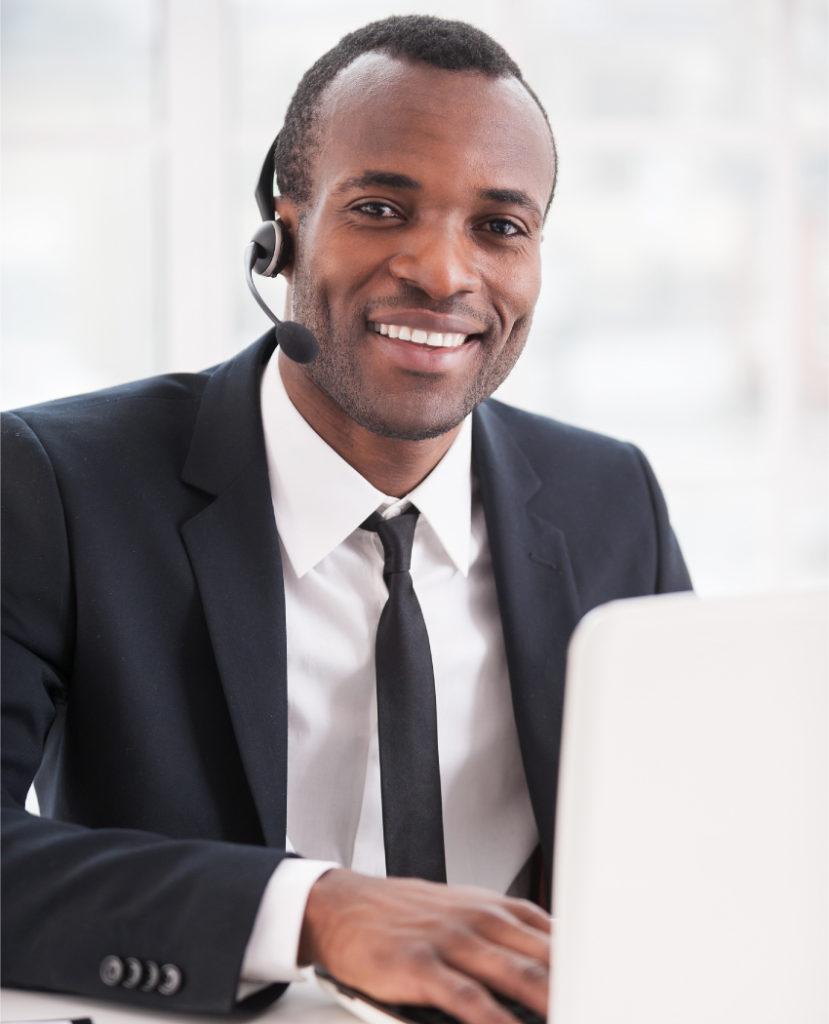 Male entrepreneur using PC to send SMS campaigns to customers via mNotify.