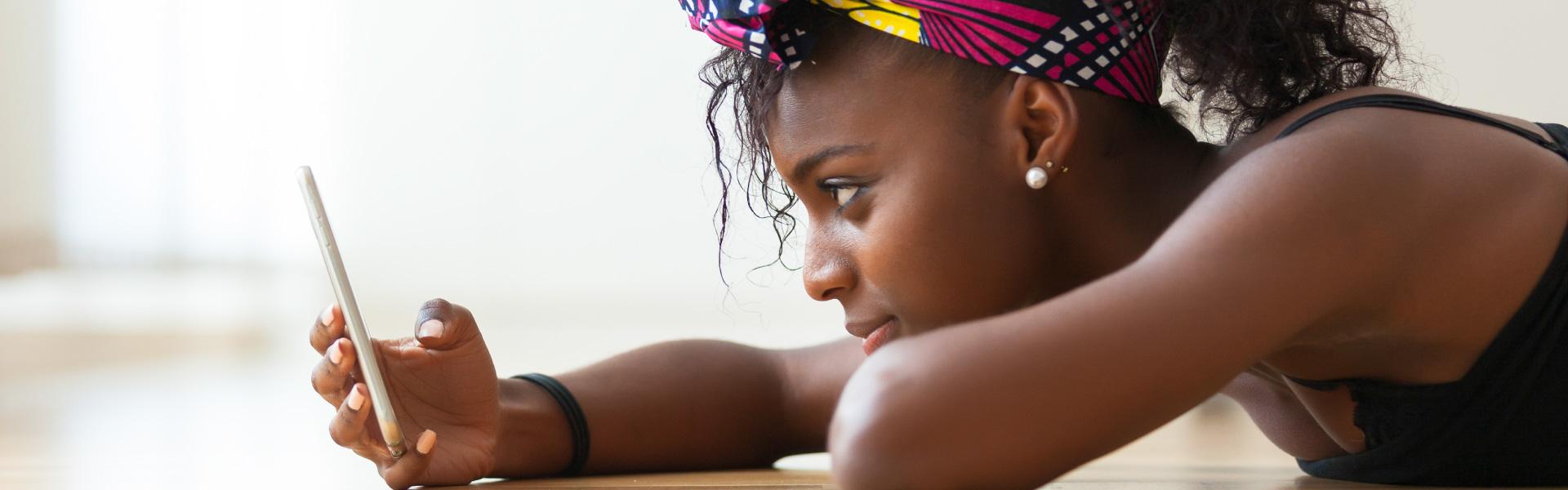 Get the best bulk SMS solutions with mNotify: Woman using our service to communicate